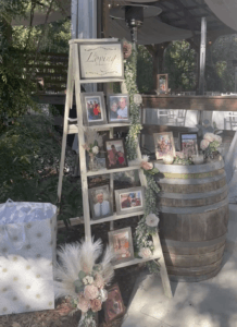 Wooden ladder with pictures and sayings in memory of loved ones that have passed at the entry of the reception barn at All4One Farms in Jacksonville, FL.